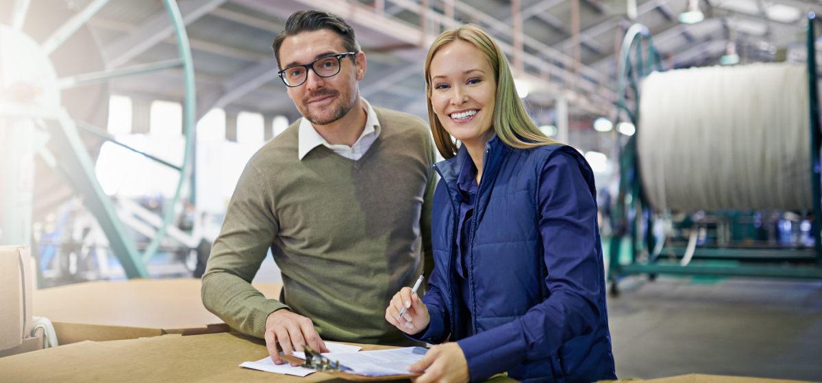 Professionals reviewing import documents in a manufacturing facility, showcasing China sourcing